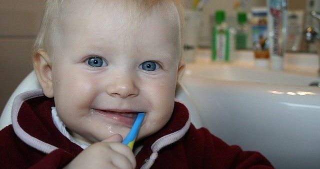 baby with toothbrush in their mouth